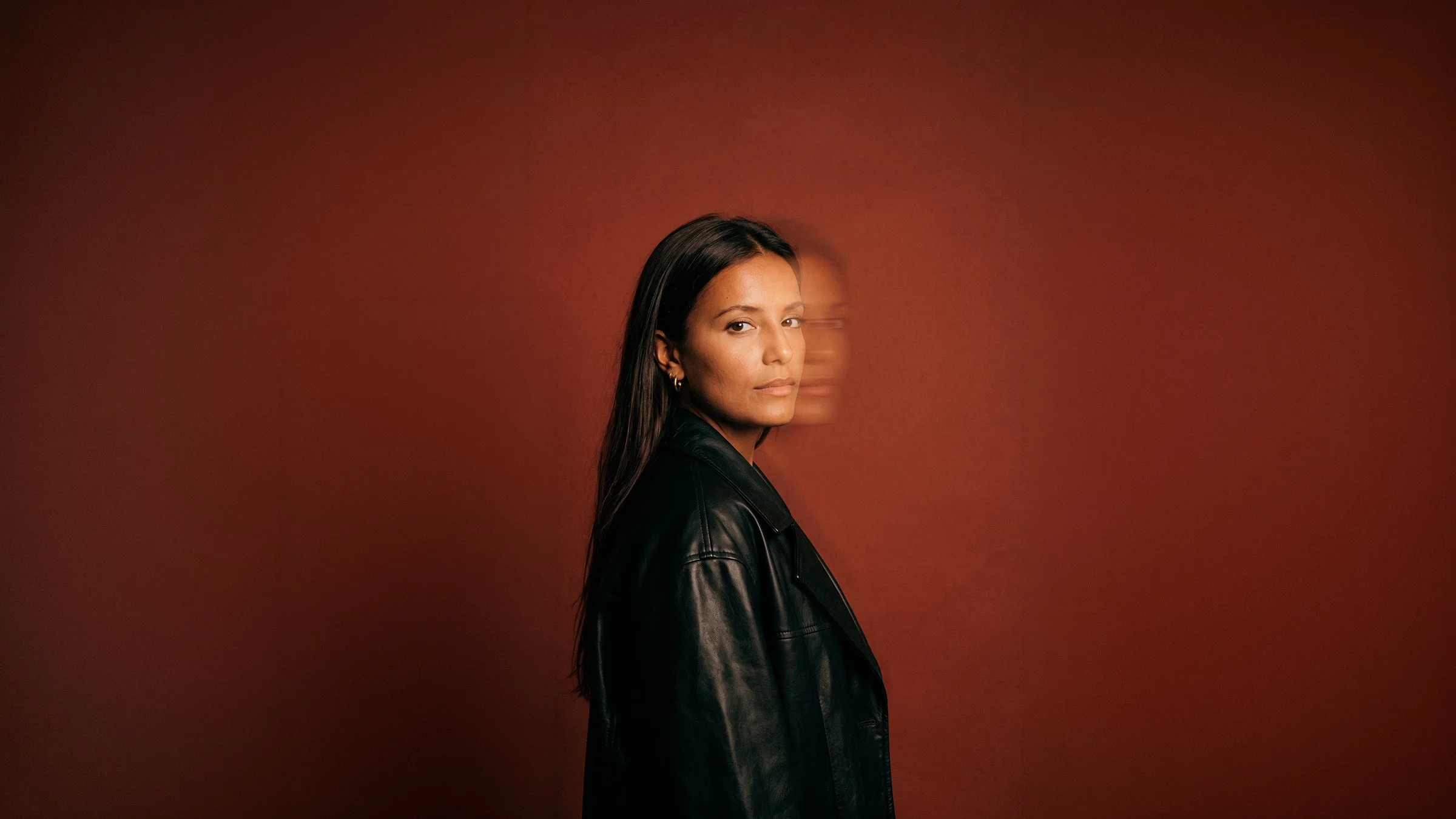Filipa Alturas in a black leather jacket against a rust background