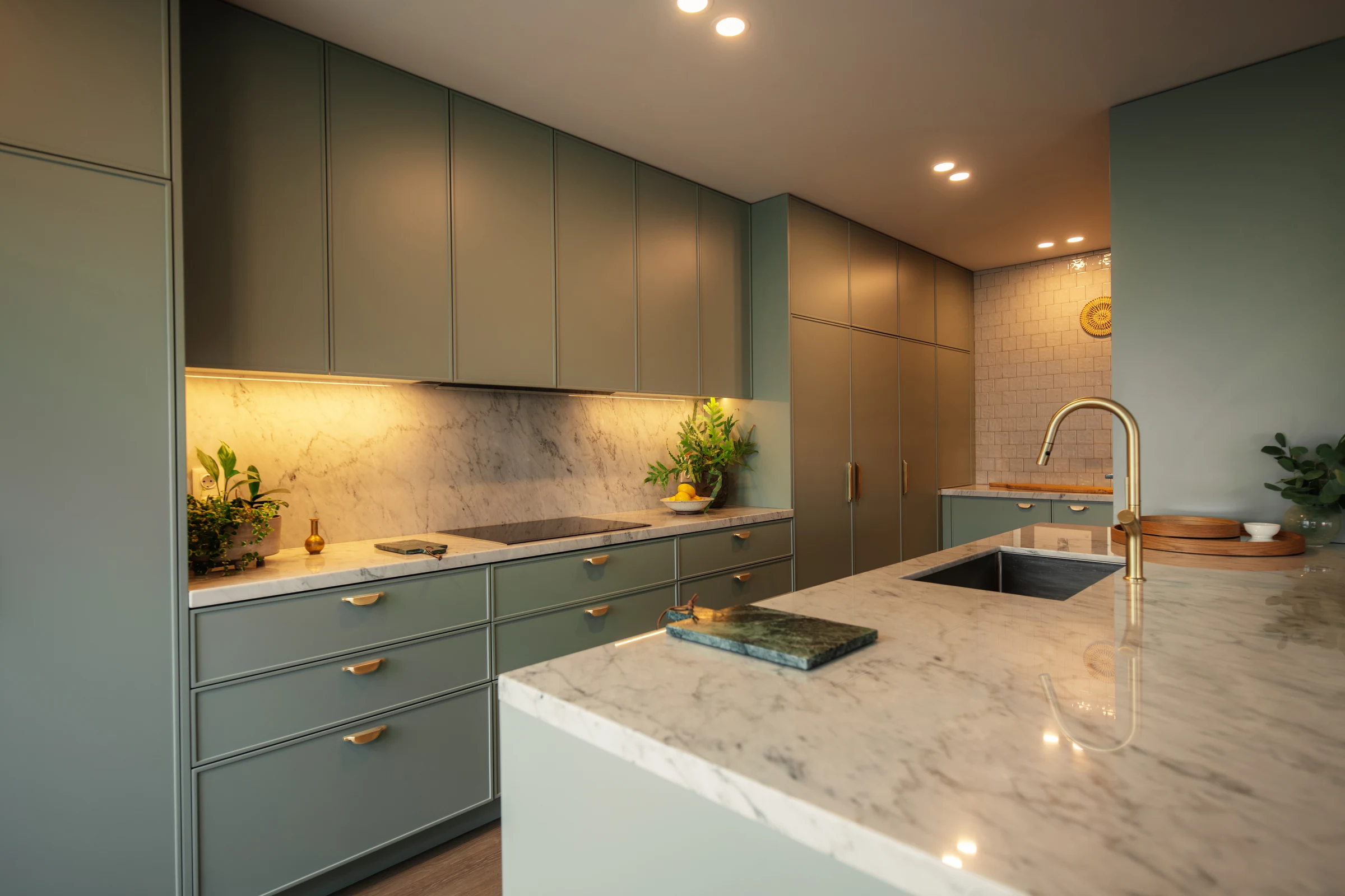 Armazém 810 bespoke sage-green kitchen with marble worktops and brass fittings
